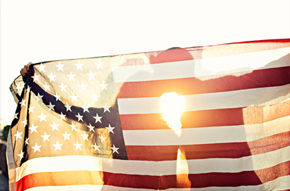 Couple kissing behind a USA flag